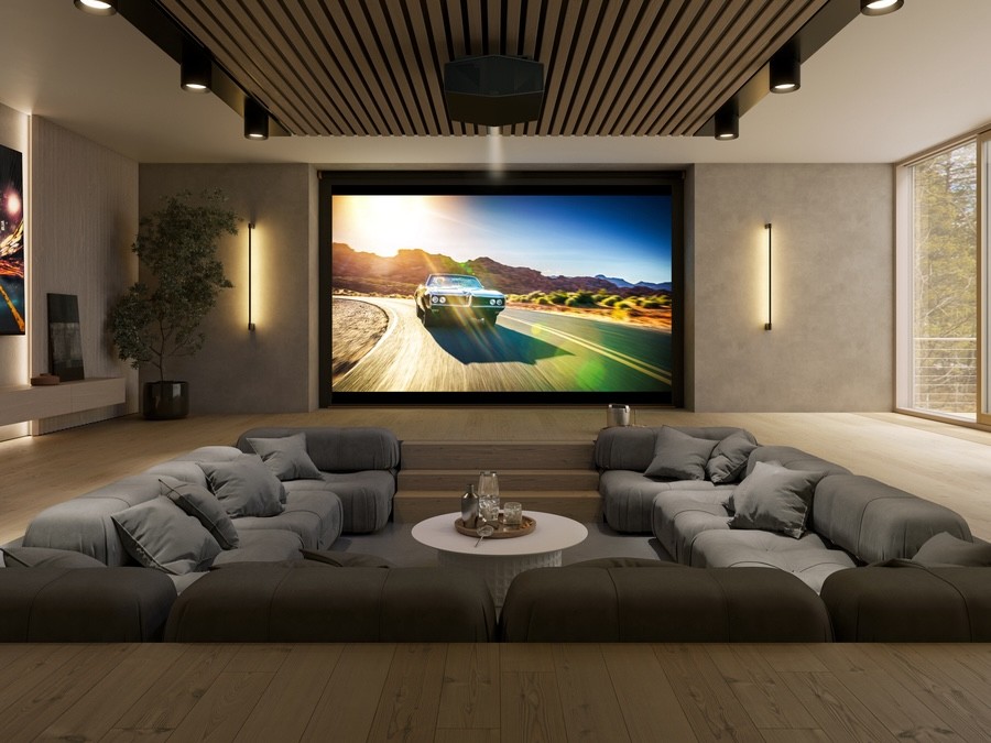 A media room with a large screen, Sony projector, and sunken sectional.