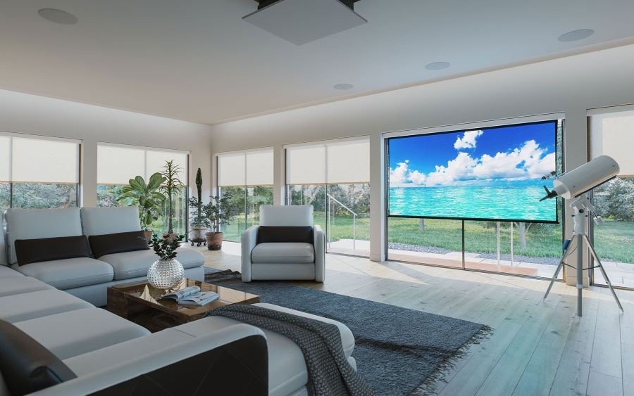 A media room with a Screen Innovations projection screen, in-ceiling speakers, and partially drawn shades.