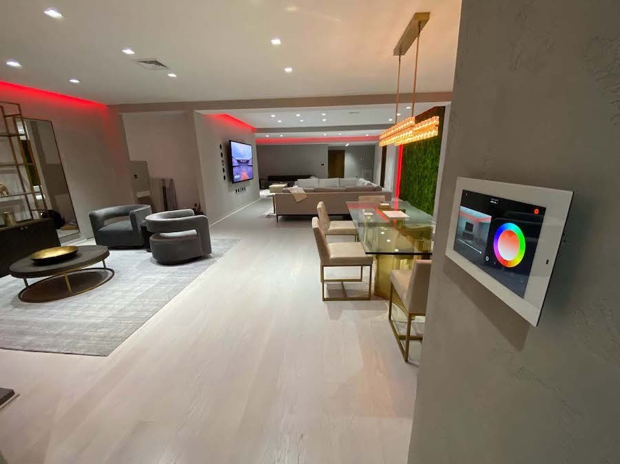 A beautifully lit room with a lighting control panel on the wall.