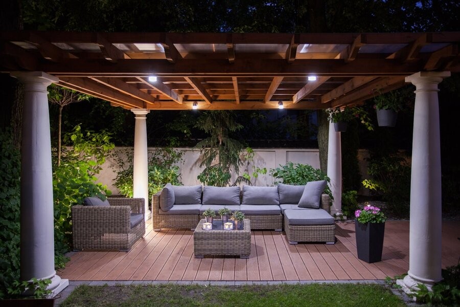 An outdoor setup under a gazebo illuminated by outdoor lighting control