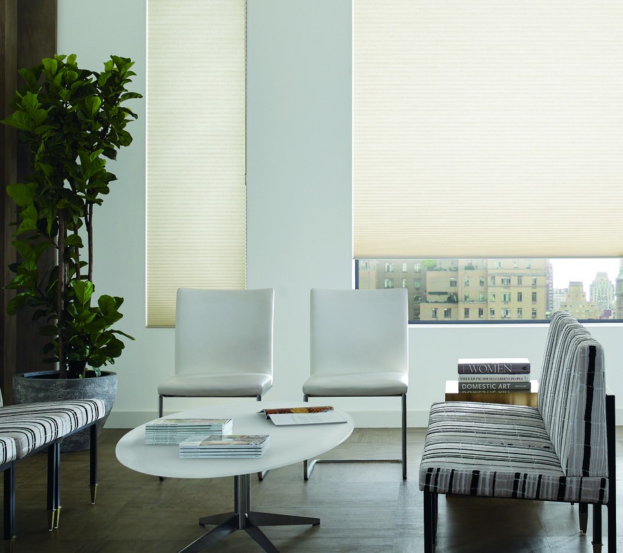A clinic waiting room with motorized blinds covering the windows.