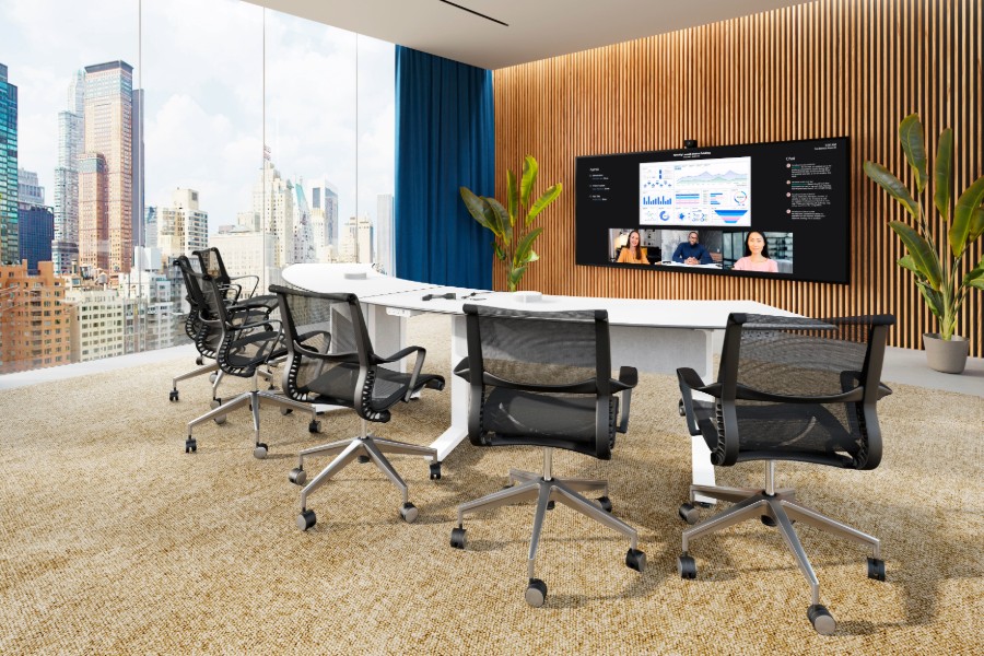 A conference room with a large screen and chairs.